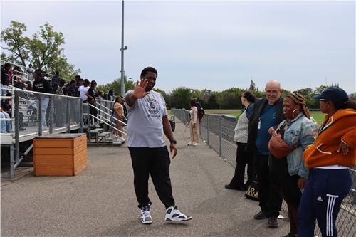 A man waving his hand, A man looking and 2 women look away